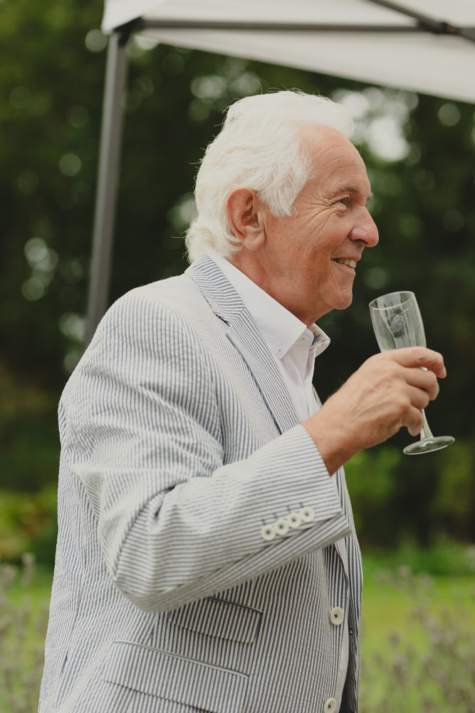 Happy newly wed couple outside Oxford Bodleian Library. Alternative confetti shot.