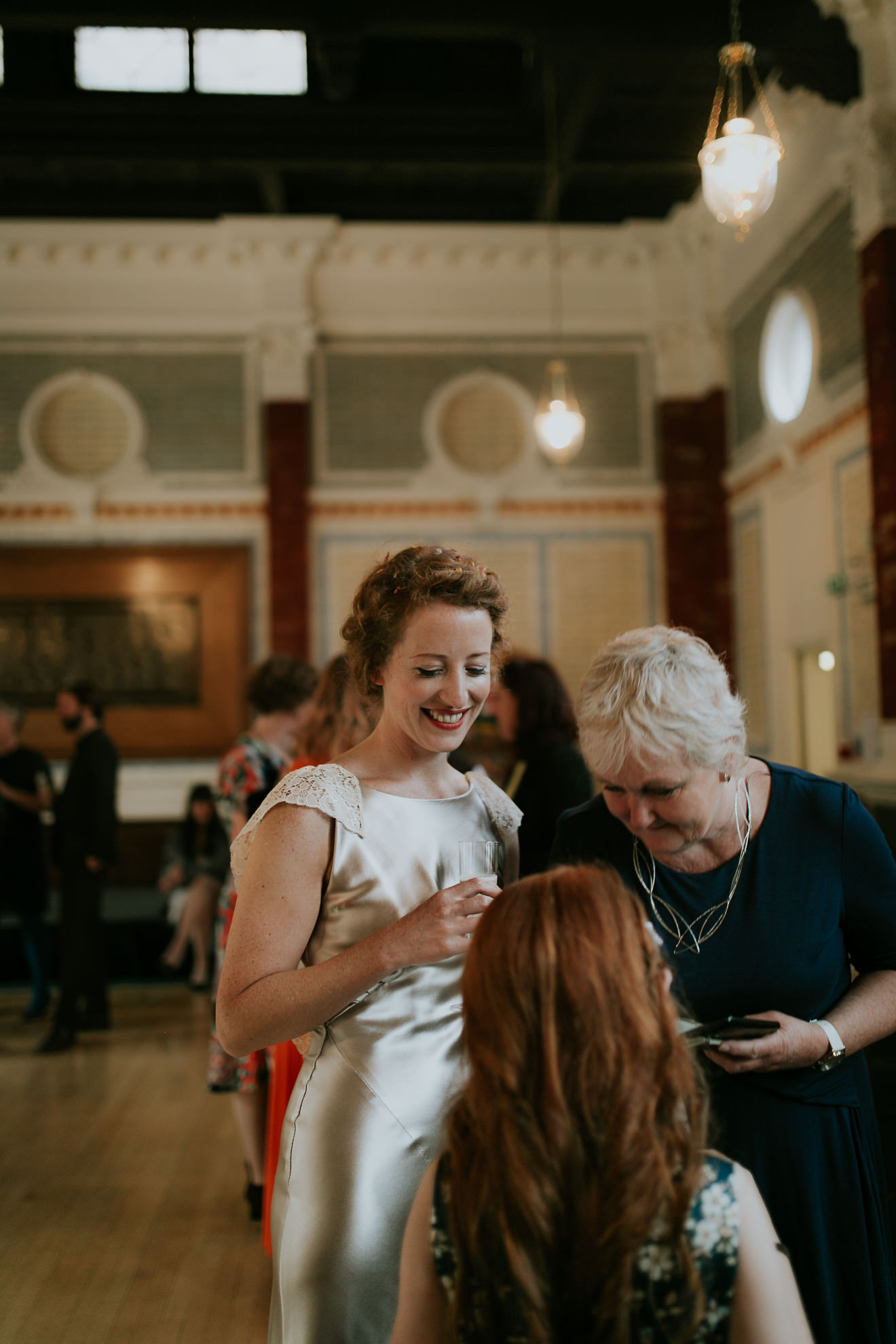 Smiling Bride in Trafalgar Warehouse talking to guests