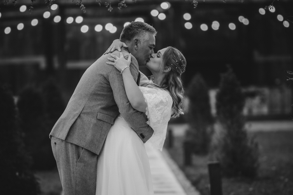 Happy newly wed couple outside Oxford Bodleian Library. Alternative confetti shot.
