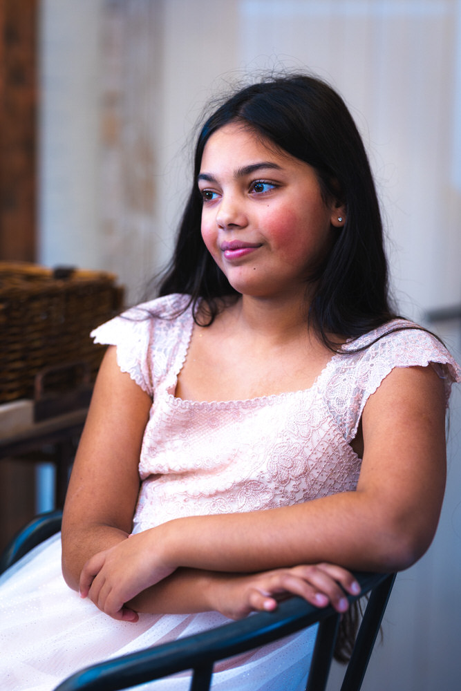 Bride and Groom cuddling under a flower arch at Elcot Park