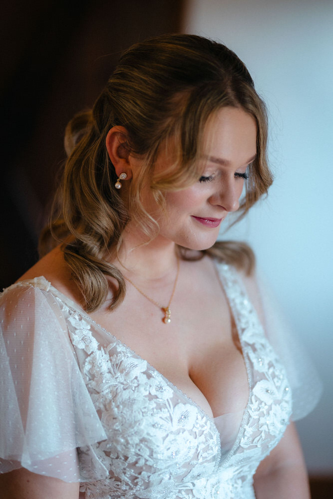 Bride in white flowing dress havign her hair done by her brides balck and white photo